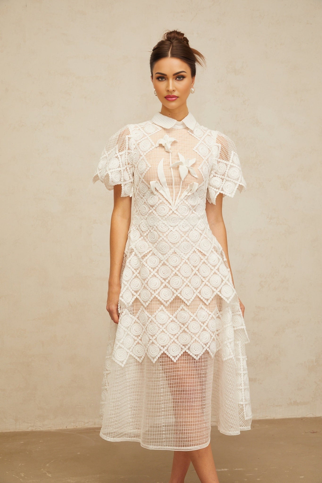 A white midi dress with floral embroidery details named Yasmine