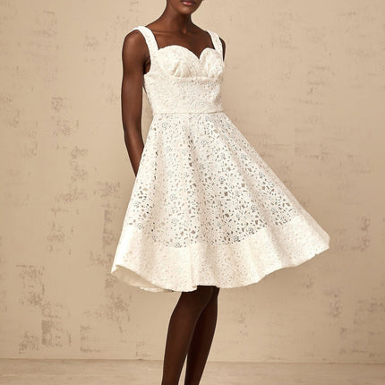 A white midi dress with floral lace pattern featuring a fitted bodice and flowing skirt