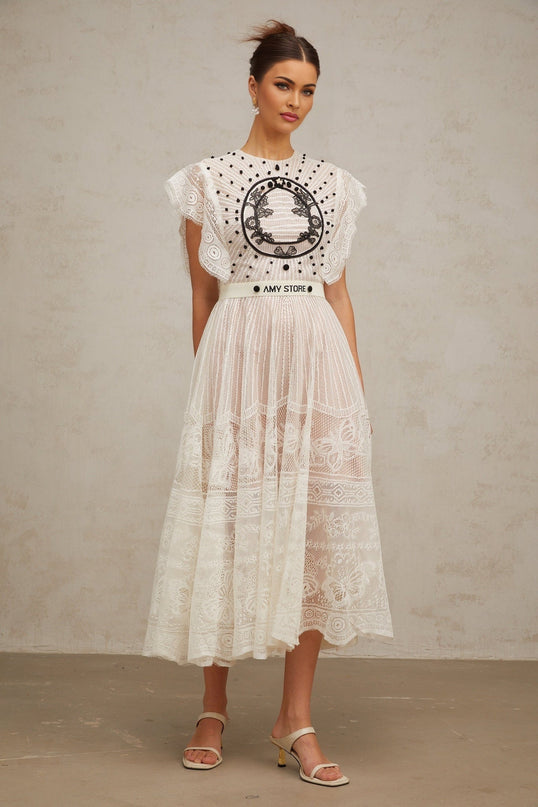 A white midi dress with jacquard floral lace pattern and pleated details named Phoebe