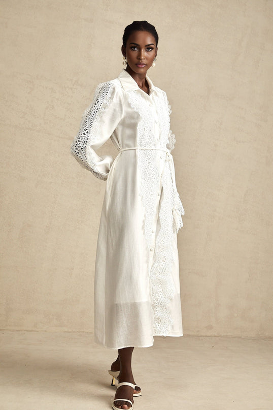 A white midi dress with lace detailing and a tied waist named Colette