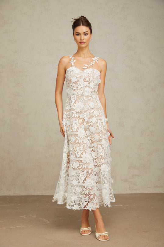 A white midi dress with lace detailing and tulle panels featuring a feminine silhouette and delicate design