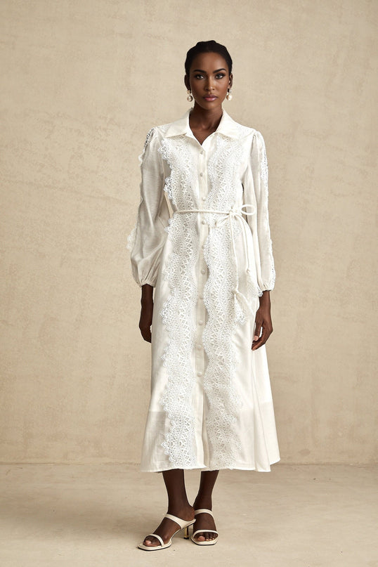 A white midi dress with lace details and a tied waist named Colette