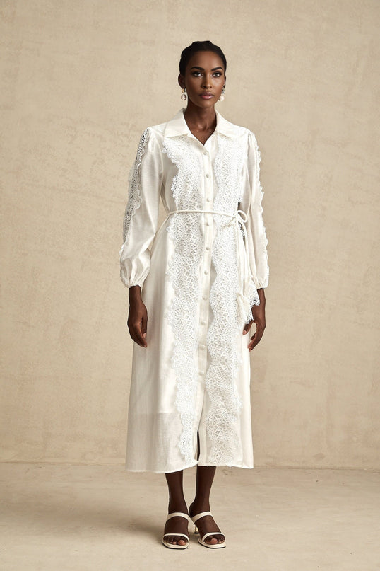 A white midi dress with lace details and a tied waist named Colette