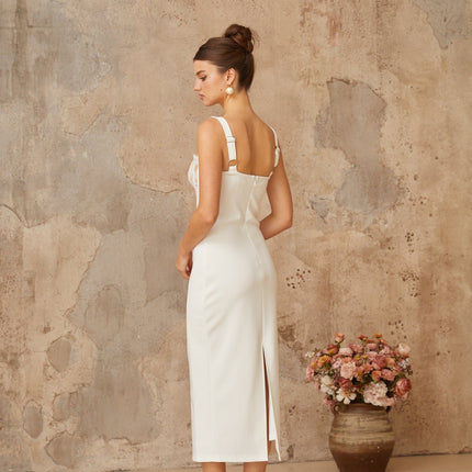A white midi dress with lace panels and corsetstyle bodice featuring a fitted silhouette and delicate feminine details