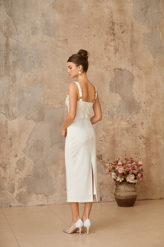 A white midi dress with lace panels and corsetstyle bodice featuring a fitted silhouette and delicate feminine details