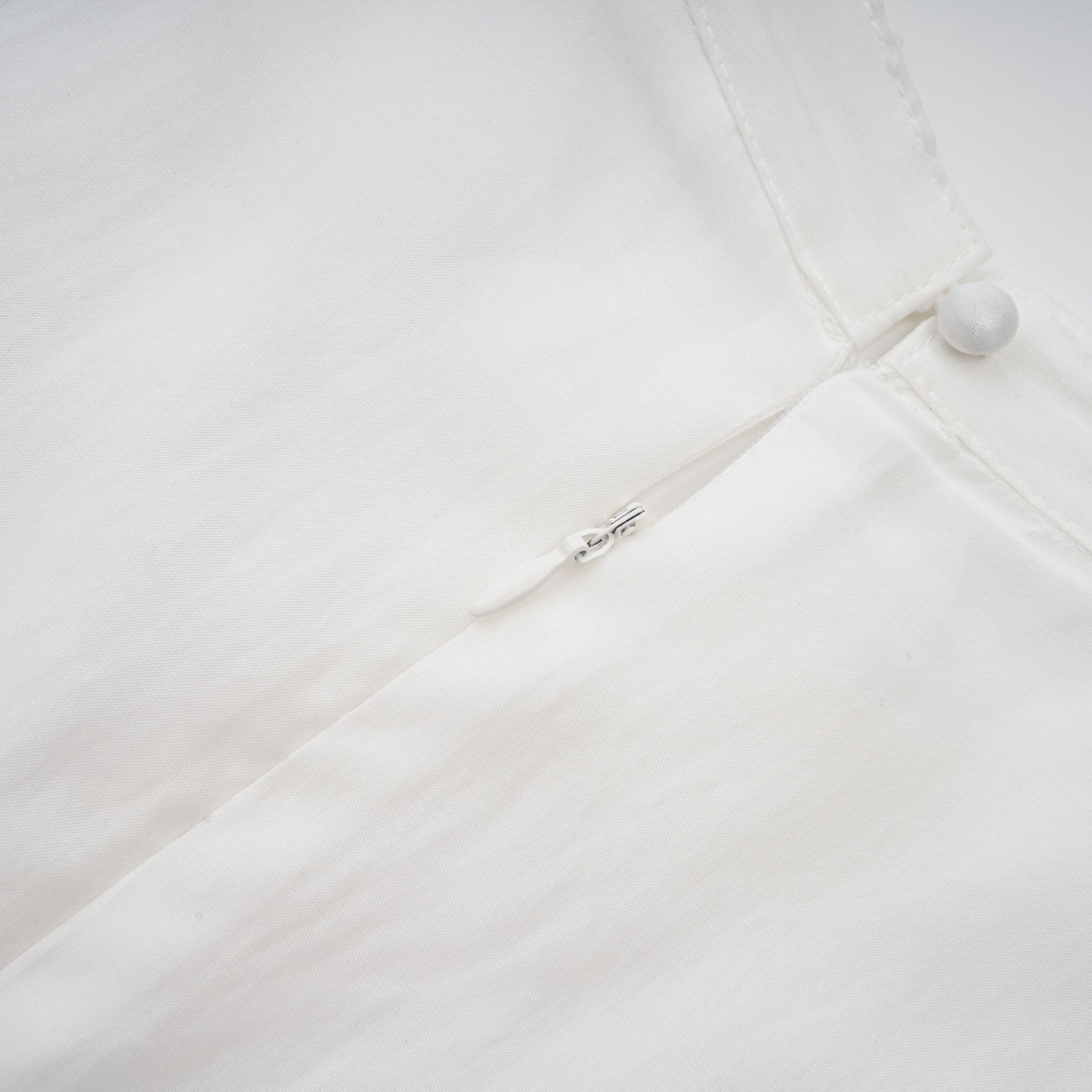A white midi dress with lace trim panels and a belted waist named Tamara