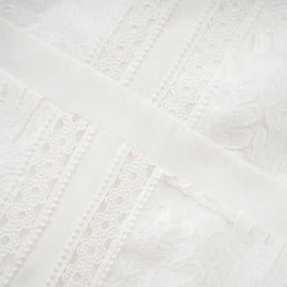 A white midi dress with panelled design and embroidery details named Madeleine featuring a feminine silhouette and delicate pattern work