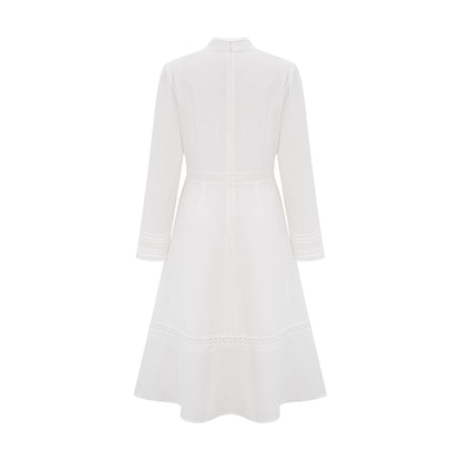 A white midi dress with panelled design and embroidery details named Madeleine featuring a feminine silhouette and delicate stitching throughout
