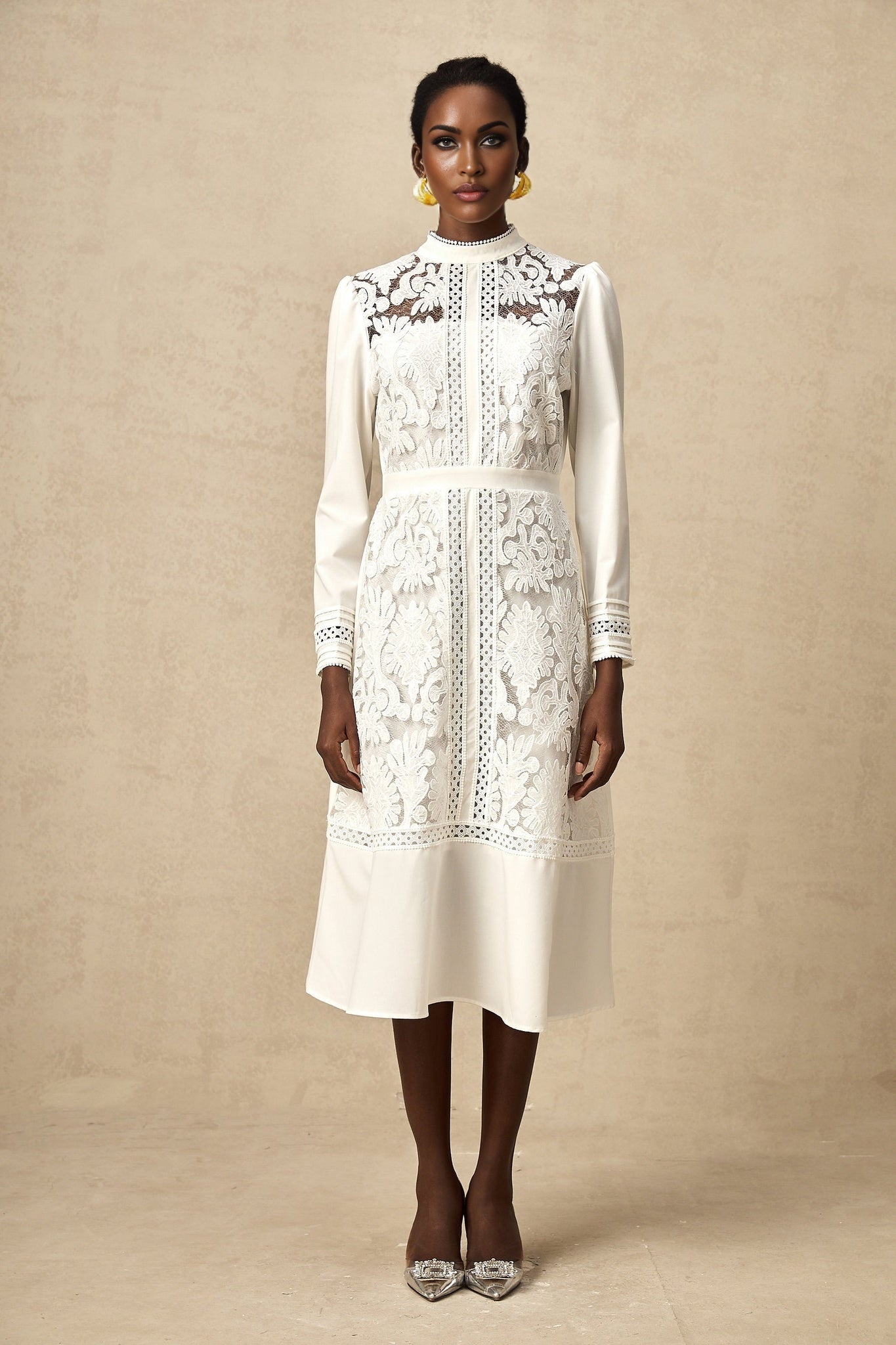 A white midi dress with panelled design and embroidery details named Madeleine featuring a fitted bodice and flared skirt