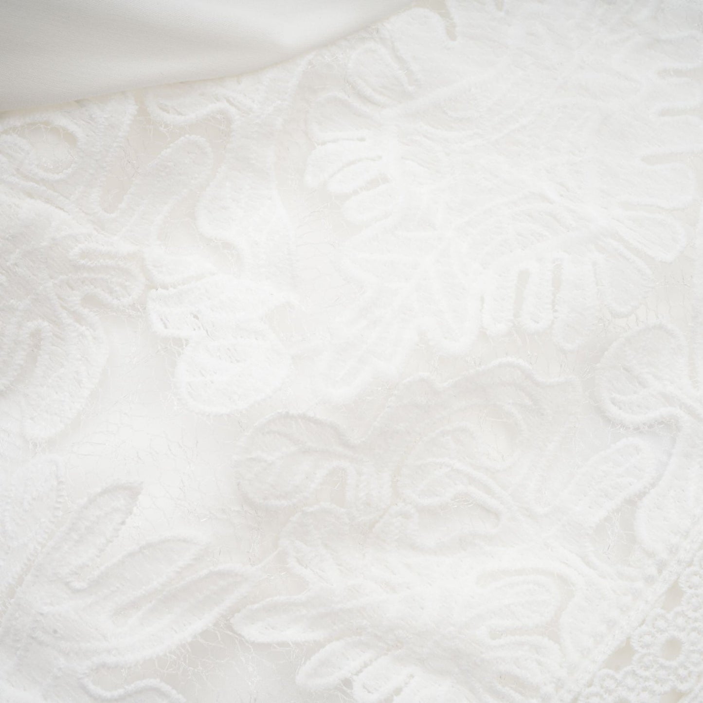 A white midi dress with panelled design and embroidery details named Madeleine featuring a fitted bodice and flowy skirt
