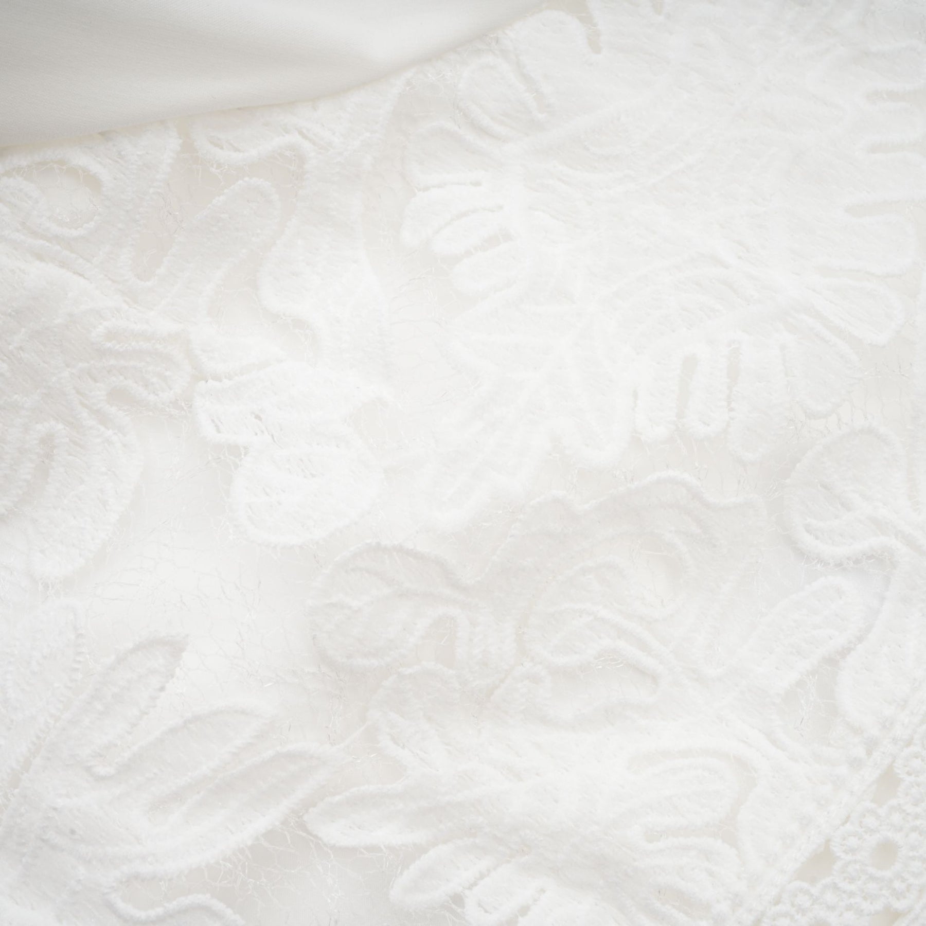 A white midi dress with panelled design and embroidery details named Madeleine featuring a fitted bodice and flowy skirt