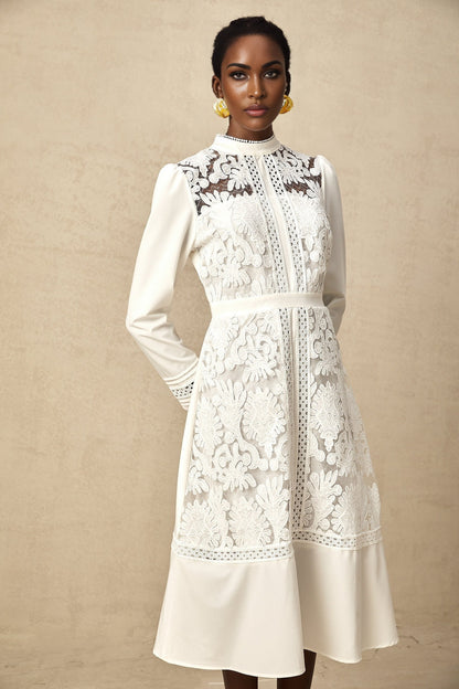A white midi dress with panelled design and embroidery details named Madeleine featuring a fitted silhouette and delicate floral patterns
