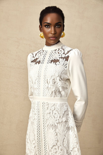 A white midi dress with panelled design and embroidery details named Madeleine featuring a sleek silhouette and delicate stitching patterns