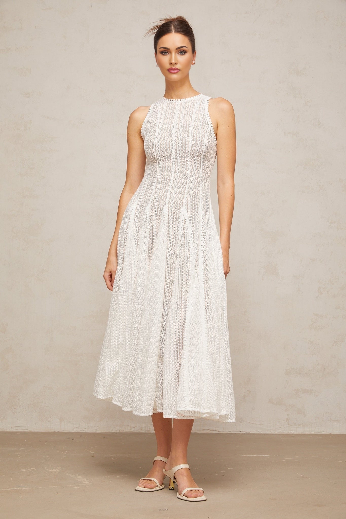 A white midi dress with pointelle detailing and puff sleeves named Helene