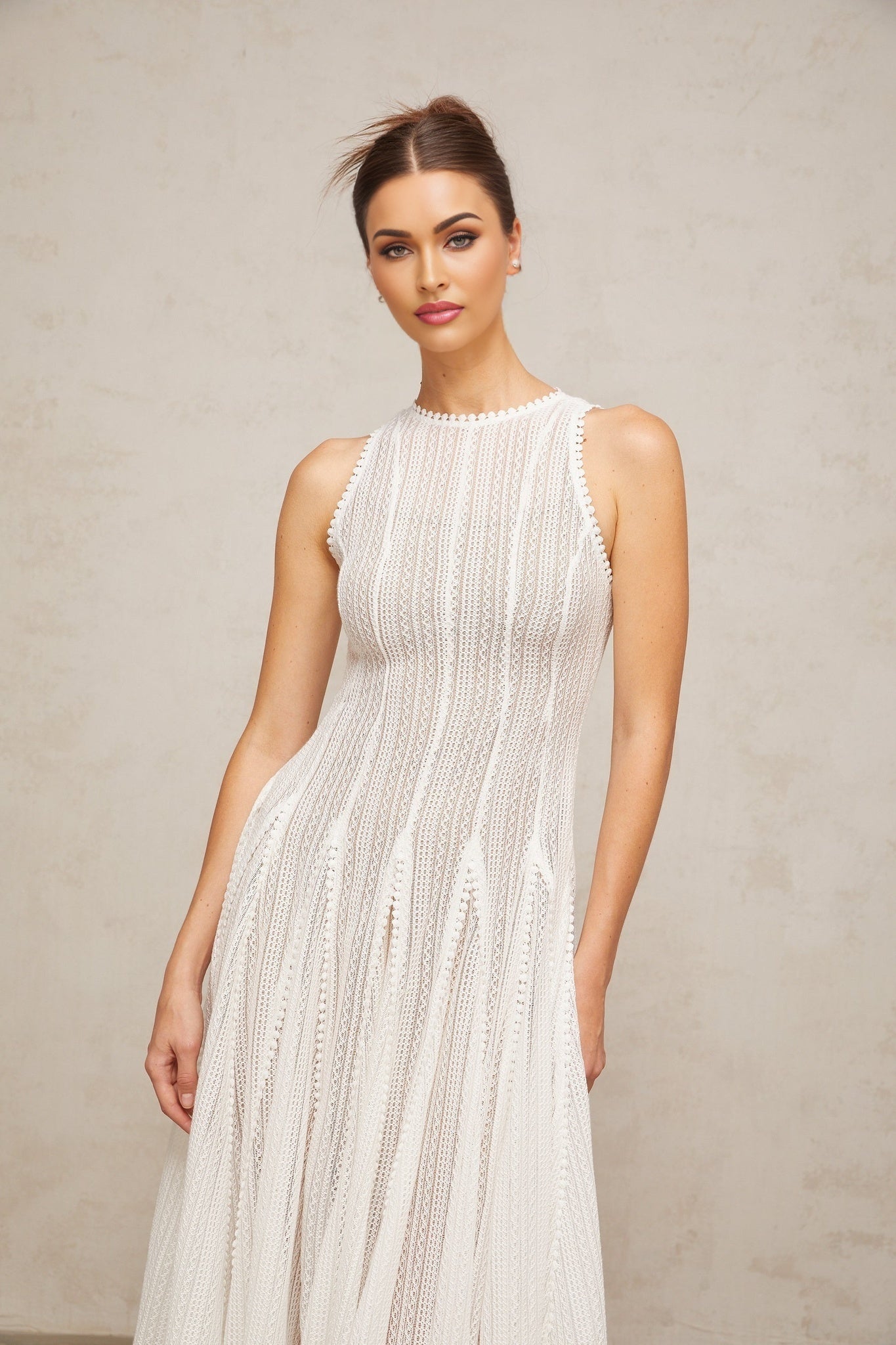 A white midi dress with puff sleeves and a pointelle knit pattern named Helene