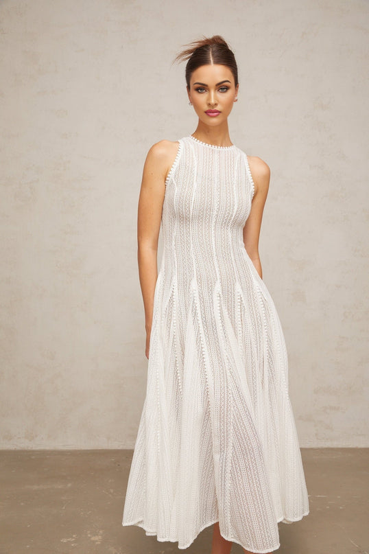 A white midi dress with puff sleeves and pointelle detailing named Helene