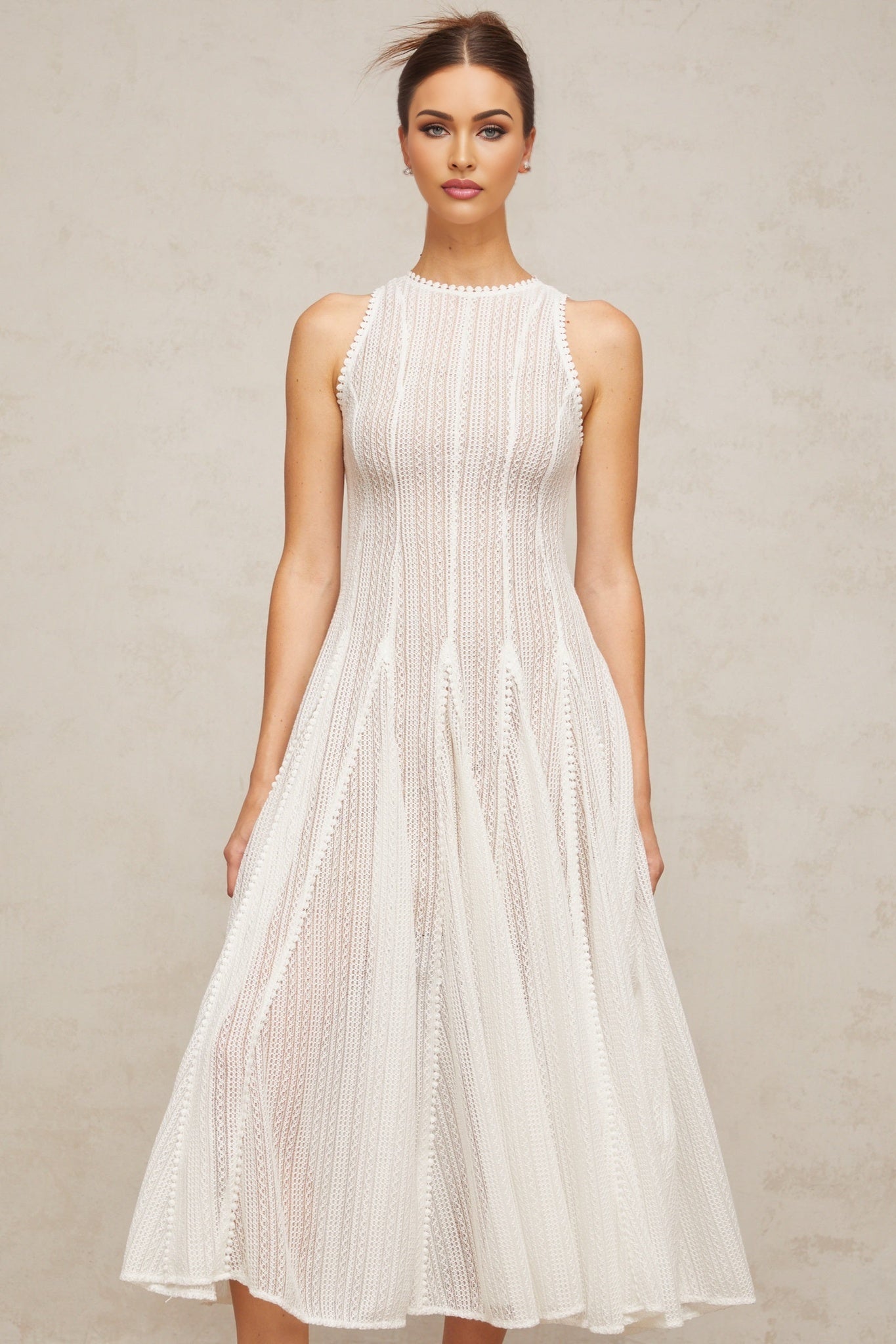 A white midi dress with puff sleeves and pointelle detailing named Helene