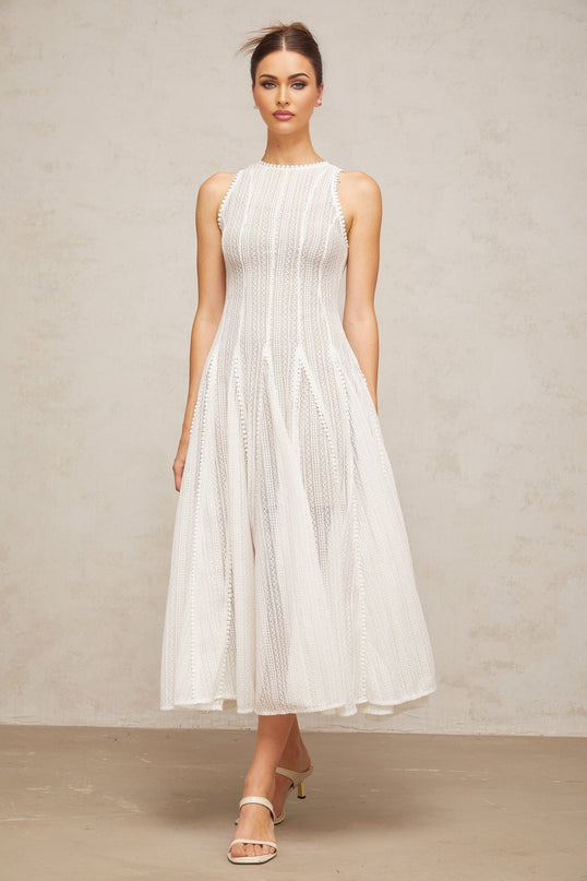 A white midi dress with puff sleeves and pointelle detailing named Helene