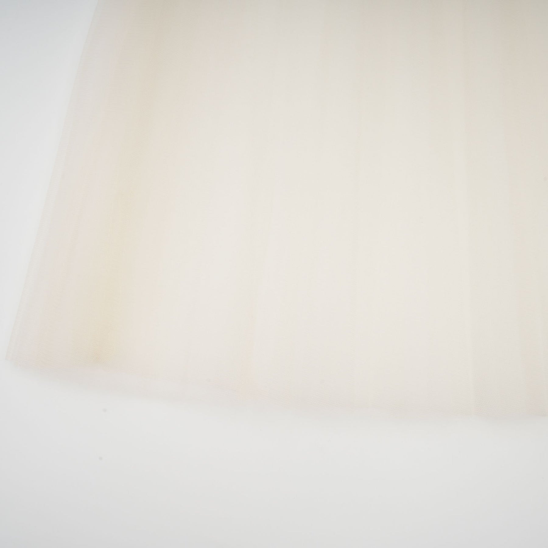 A white midi dress with tulle panels and a bowknot detail named Therese