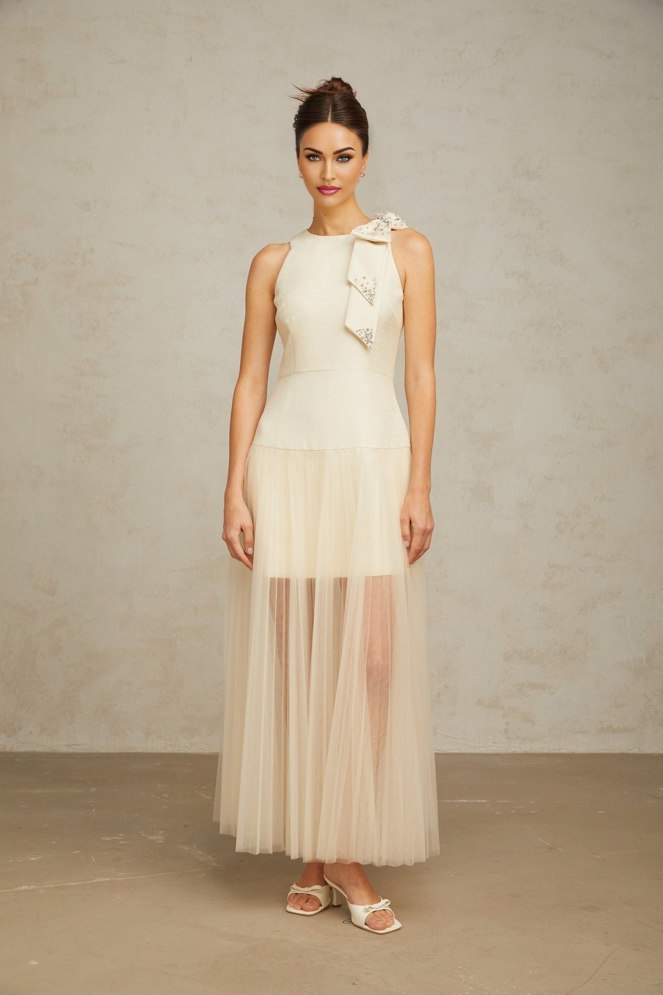 A white midi dress with tulle panels and a decorative bow detail named Therese