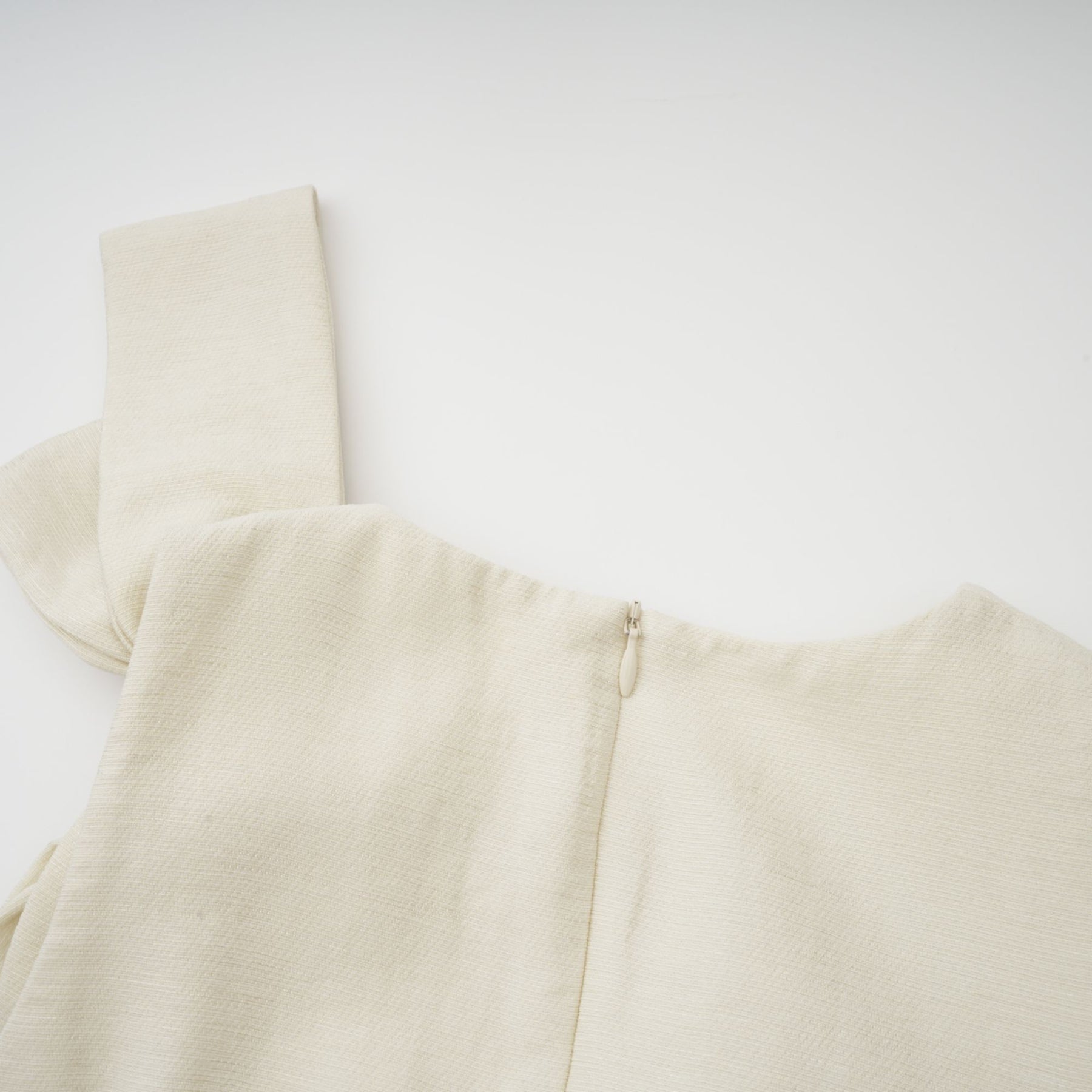 A white midi dress with tulle panels and a decorative bowknot detail named Therese