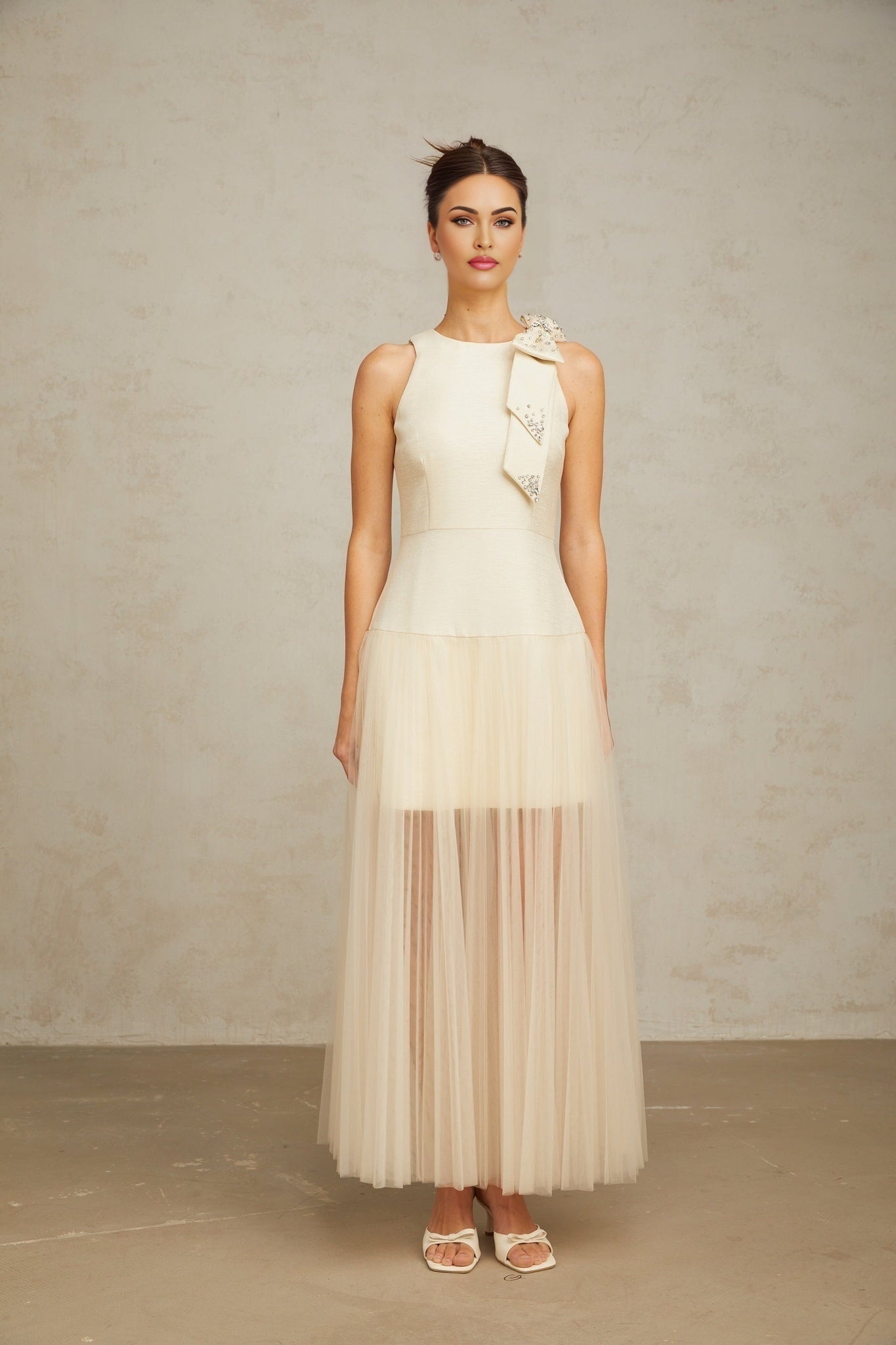 A white midi dress with tulle panels and a decorative bowknot detail named Thérèse