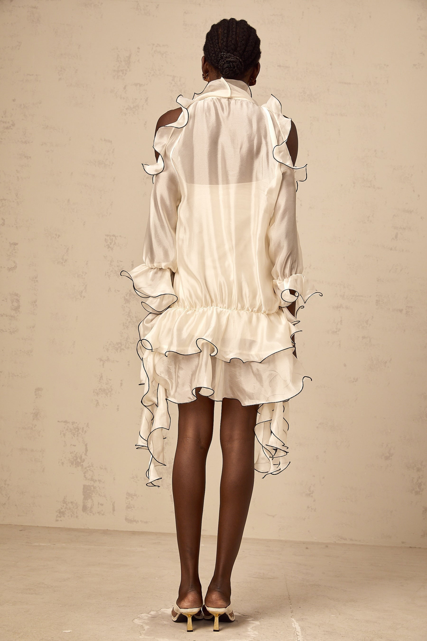A white mini dress with a flounced skirt and ribbon details named Tiphaine