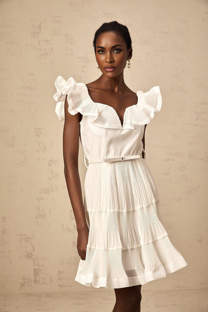 A white mini dress with a frilled neckline and pleated design named Eliane