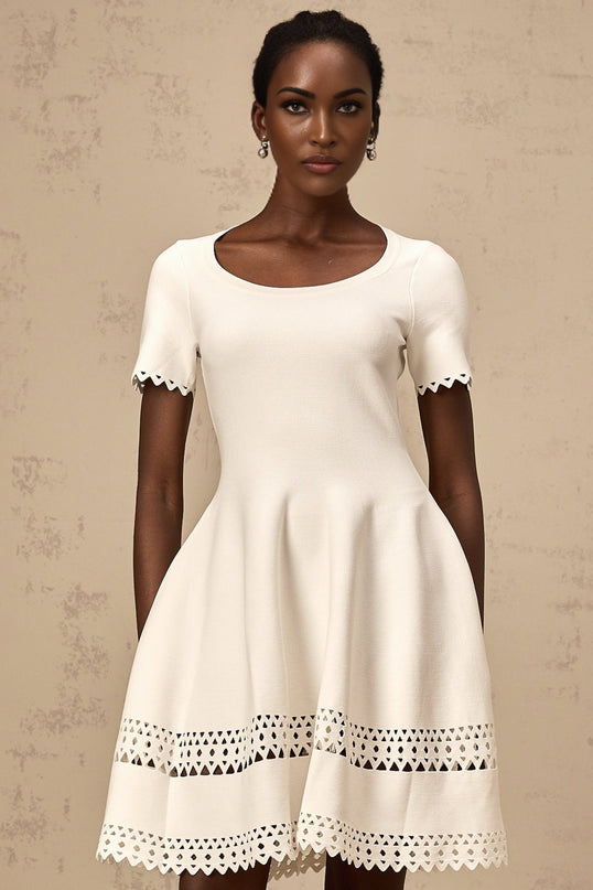 A white mini dress with a knitted texture featuring cut out details and a fleur design pattern