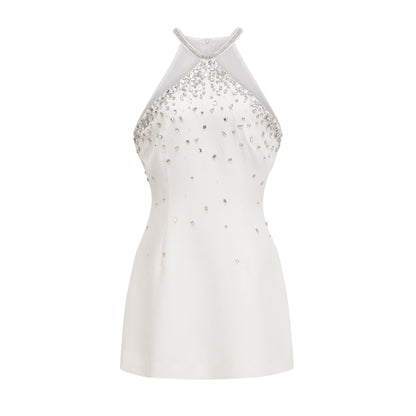 A white mini dress with embellishments called the Xanthea featuring a short hemline and decorative details