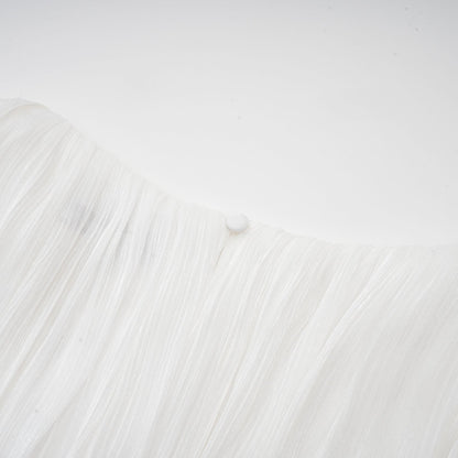 A white mini dress with full pleats and a cinched waist detail featuring a rosier design
