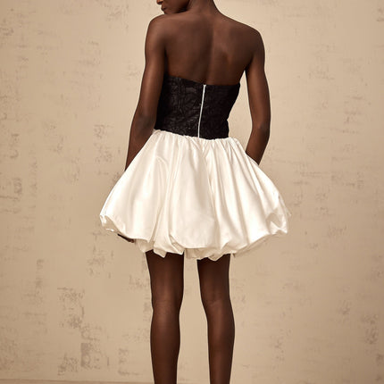 A white mini dress with puff sleeves featuring lace panels and a satin finish named Éliane