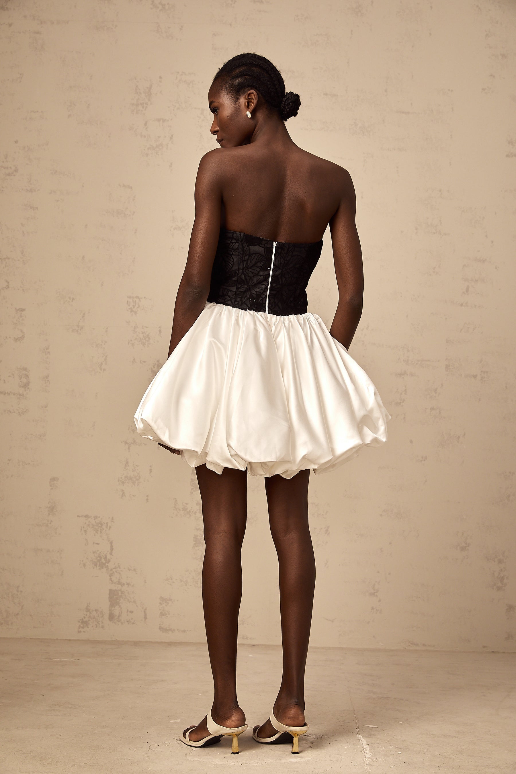 A white mini dress with puff sleeves featuring lace panels and a satin finish named Éliane