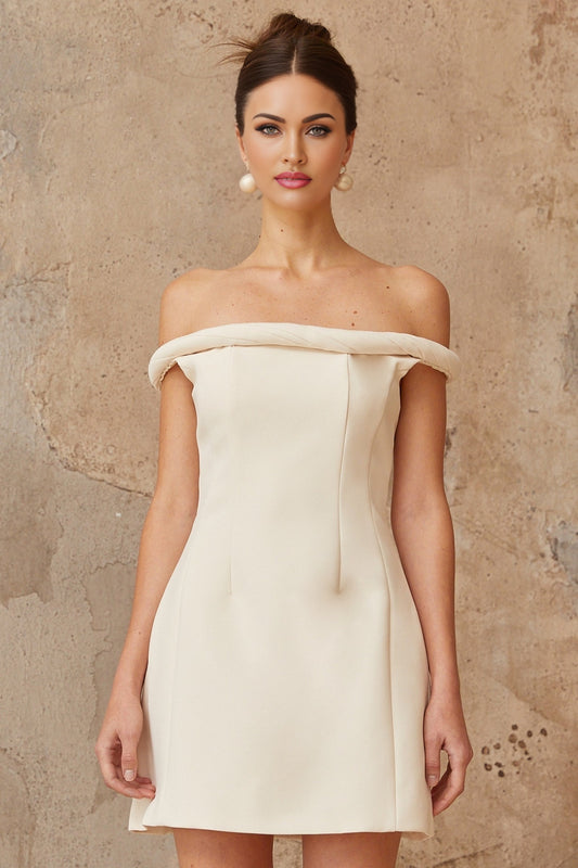A white mini dress with puffed sleeves and braided detailing featuring a short hemline and a feminine silhouette