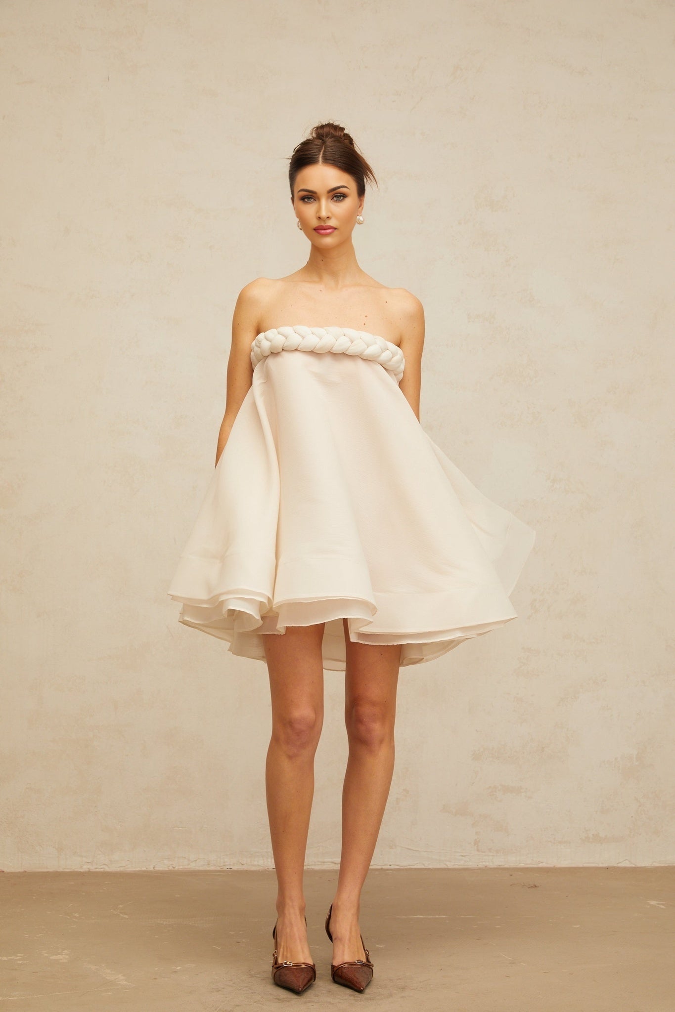 A white mini dress with puffed sleeves and braided details named Violette