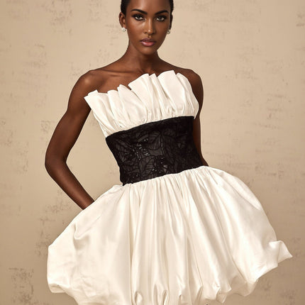 A white mini dress with puffed sleeves featuring satin fabric and lace paneling details named Eliane