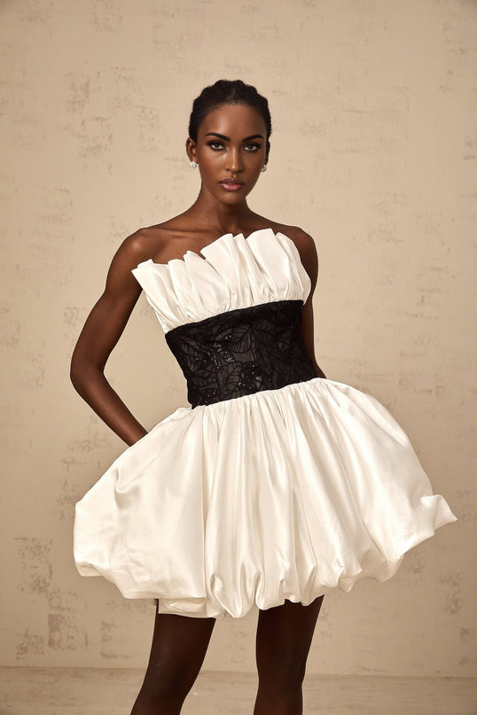 A white mini dress with puffed sleeves featuring satin fabric and lace paneling details named Eliane