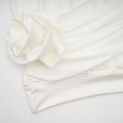 A white mini dress with ruched detailing and faux flower embellishments named Maeva