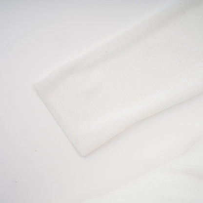 A white offshoulder maxi dress with panel detailing worn by a model named Nadine