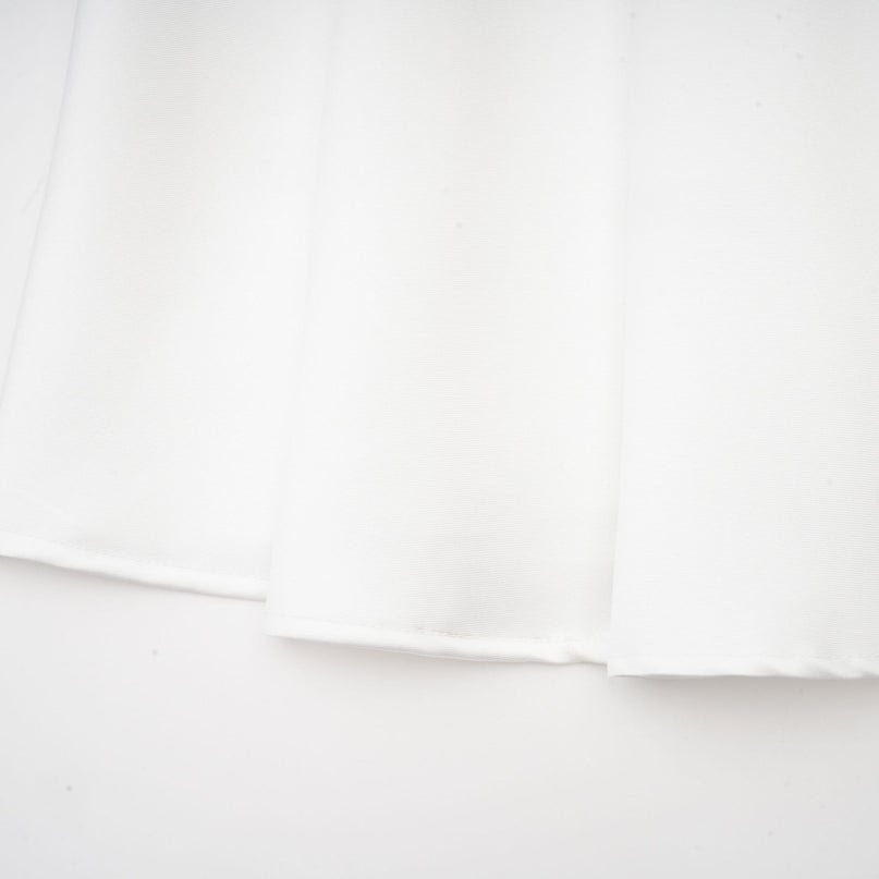 A white offshoulder maxi dress with panelled design featuring a long flowing skirt and fitted bodice on a female model