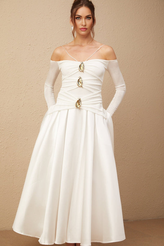 A white offshoulder maxi dress with panels worn by a model standing against a plain background