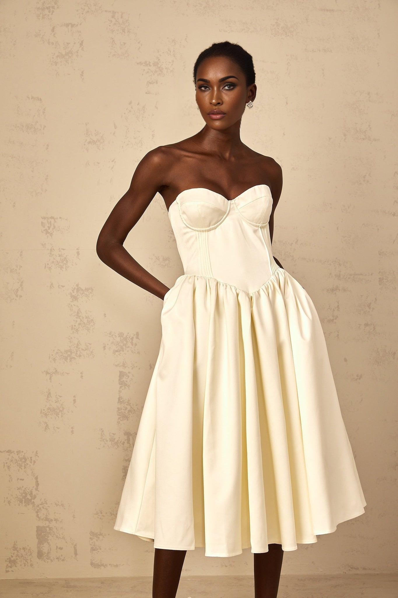 A white offshoulder midi dress for women with shirred detailing featuring a fitted bodice and flowing skirt