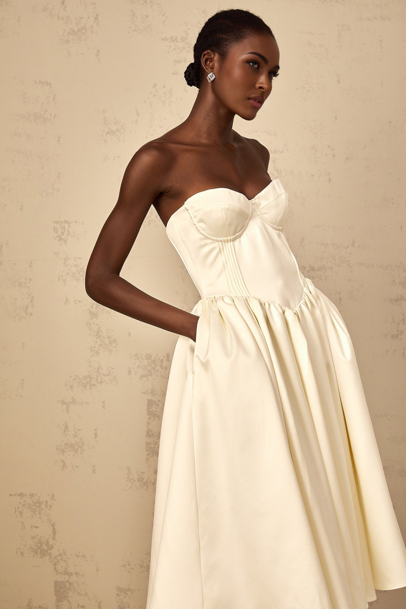 A white offshoulder midi dress for women with shirred detailing featuring a fitted bodice and flowing skirt