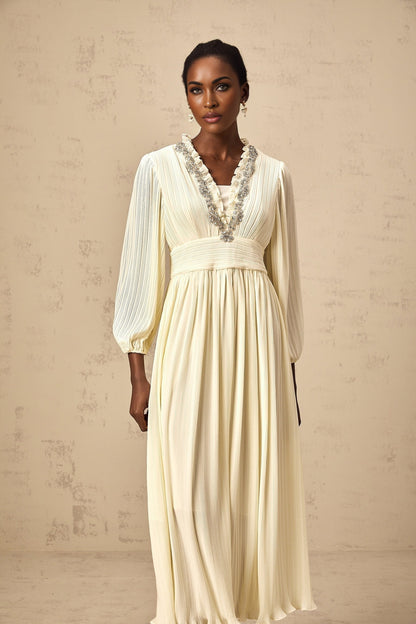 A white pleated midi dress with crystal trim detailing named Yana
