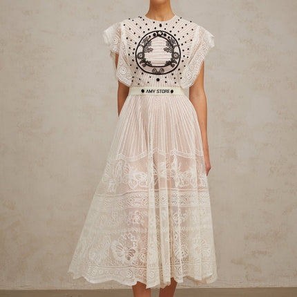 A white pleated midi dress with jacquard floral lace pattern named Phoebe featuring a delicate design and flowing silhouette