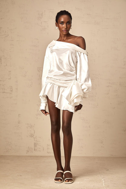 A white satin mini dress with a deconstructed design featuring asymmetrical panels and draping named Xenia