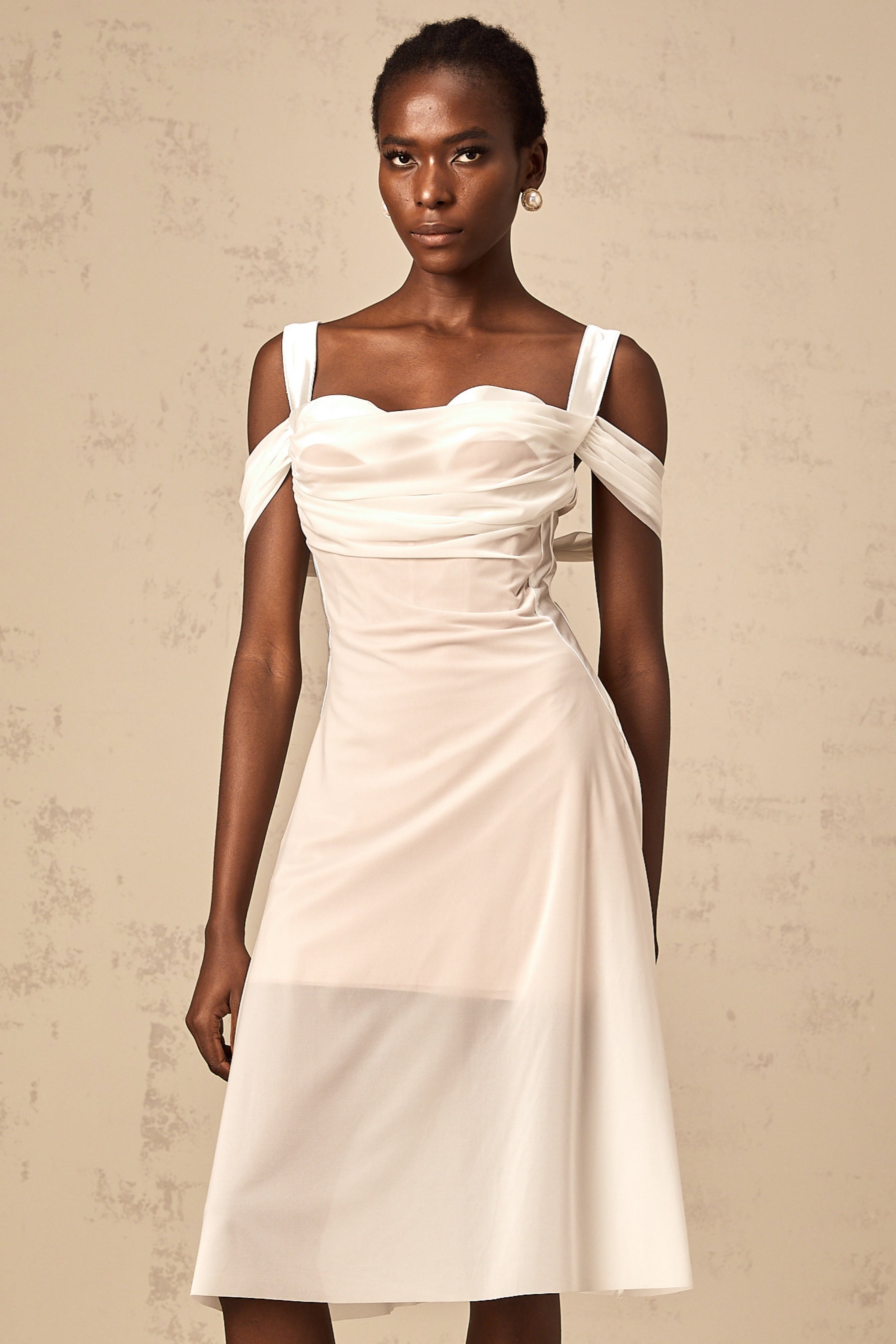 A white semi sheer midi dress with ruched detailing named Gloria
