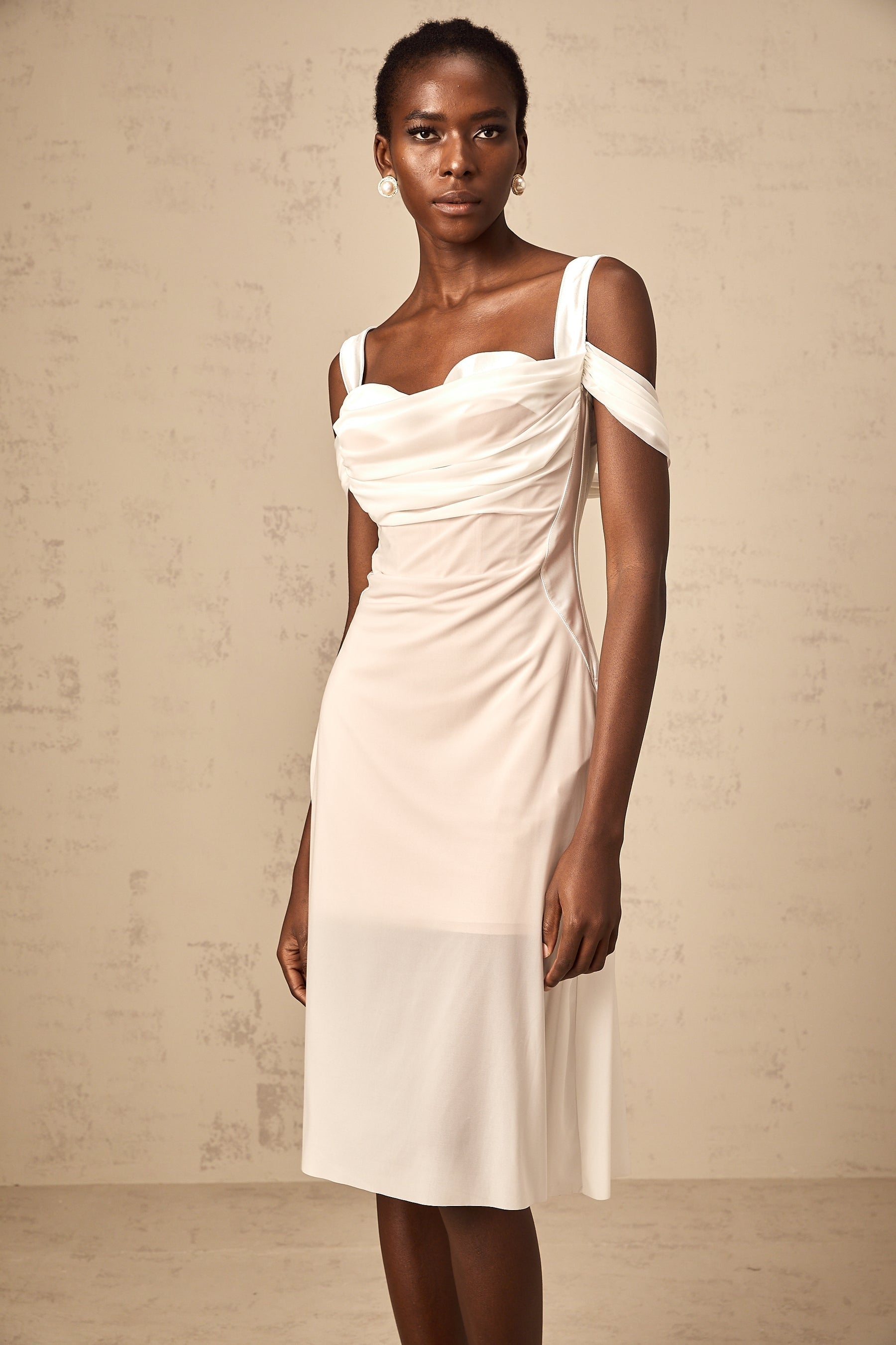 A white semi sheer midi dress with ruched detailing named Gloria