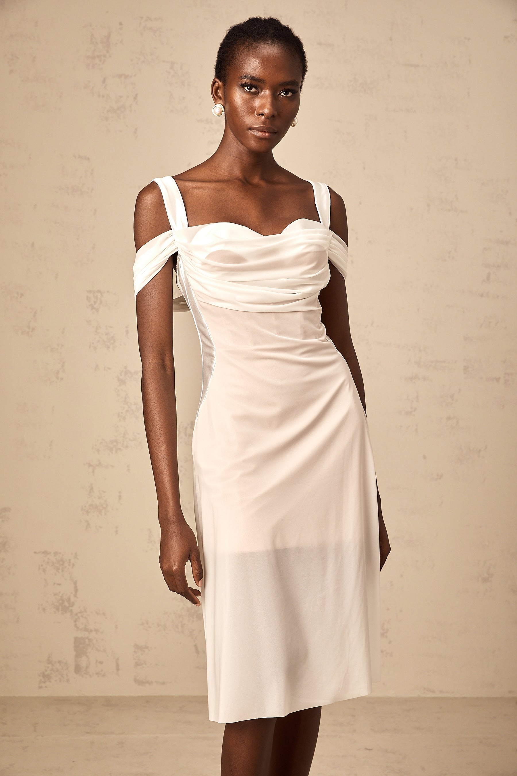 A white semi sheer midi dress with ruched detailing named Gloria