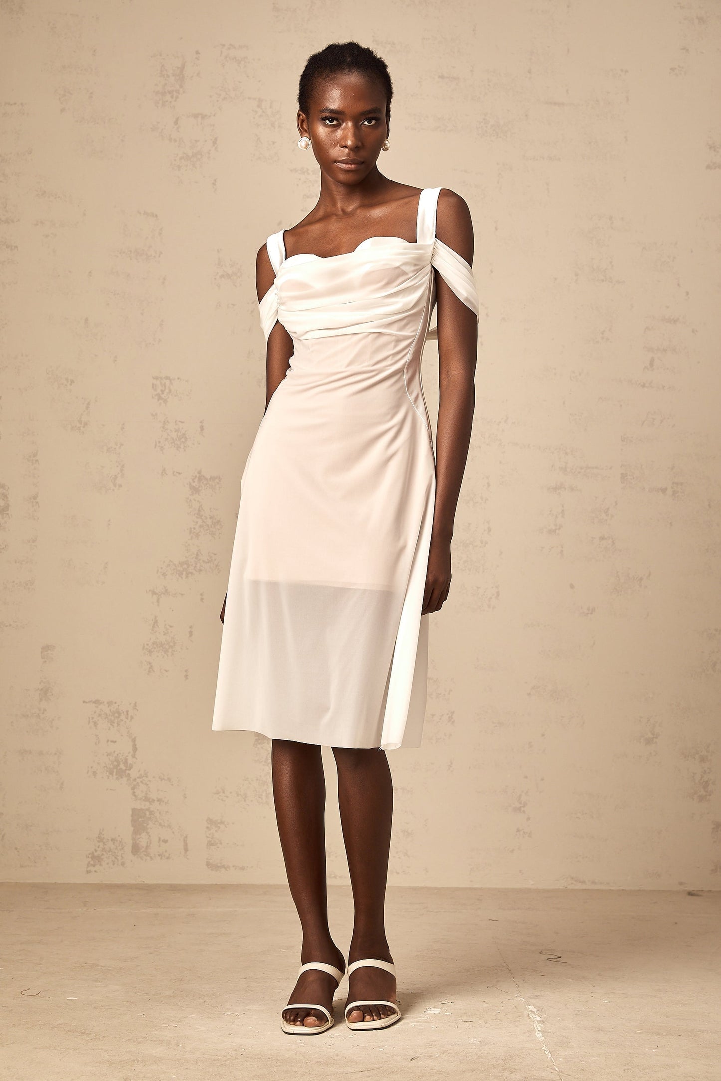 A white semi sheer midi dress with ruched detailing named Gloria